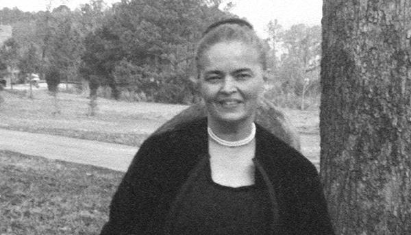 woman outside wearing pearls